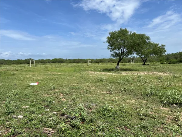 a view of backyard of house with seating