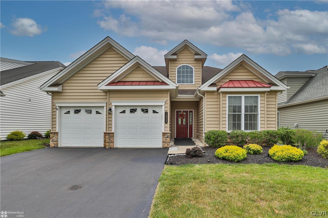 a view of front of a house with a yard and garage