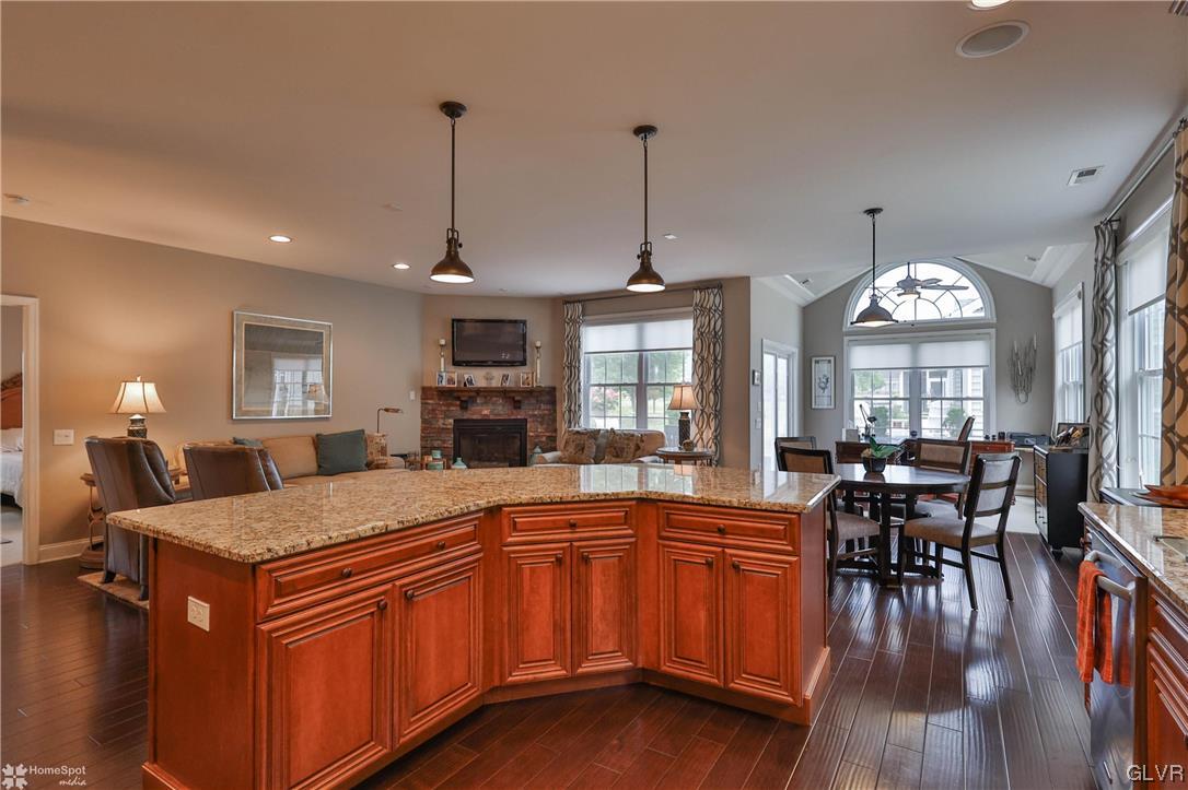 1035 Declaration Drive Bethlehem, PA 18017 - Photo 14 of 38 a kitchen with stainless steel appliances granite countertop a stove top oven a dining table and chairs with wooden floor