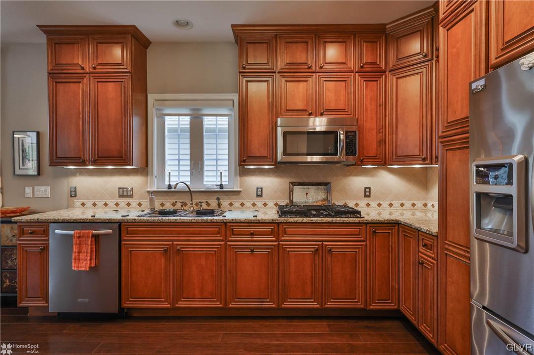 1035 Declaration Drive Bethlehem, PA 18017 - Photo 15 of 38 a kitchen with stainless steel appliances granite countertop a sink stove and refrigerator