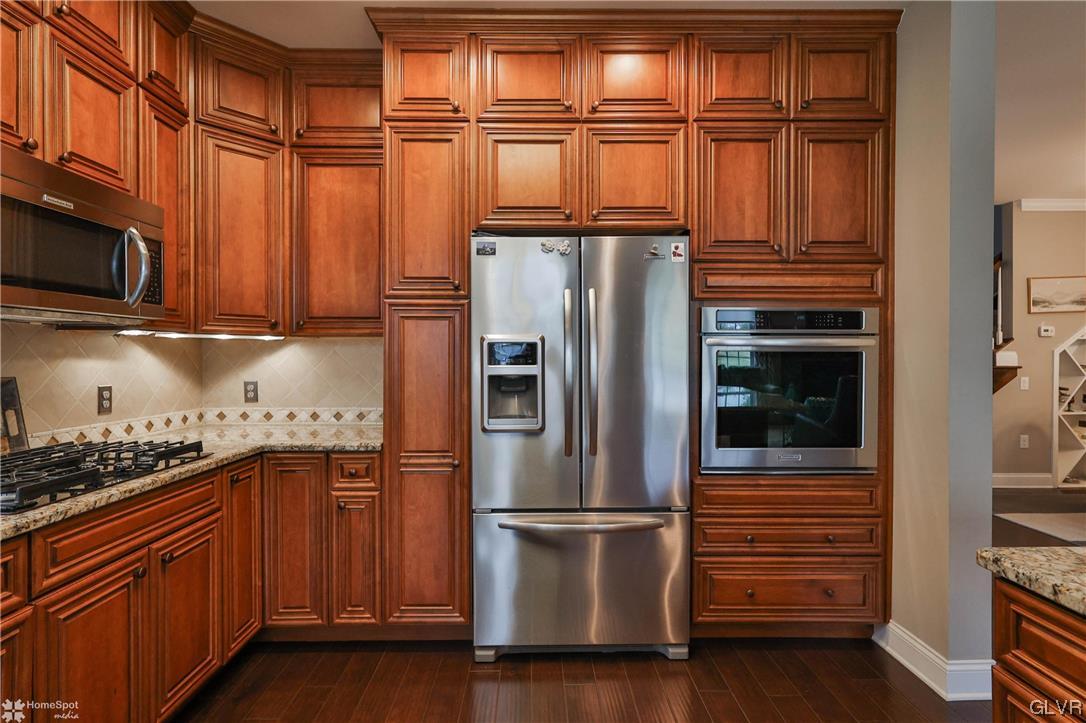 1035 Declaration Drive Bethlehem, PA 18017 - Photo 16 of 38 a kitchen with stainless steel appliances granite countertop a refrigerator and a stove top oven