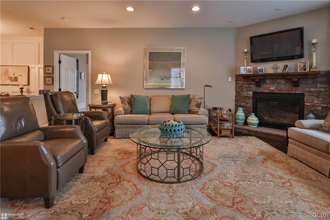 1035 Declaration Drive Bethlehem, PA 18017 - Photo 22 of 38 a living room with furniture a flat screen tv and a fireplace