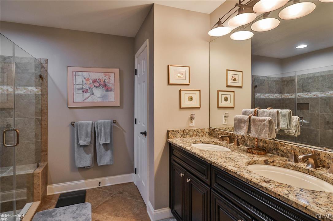 1035 Declaration Drive Bethlehem, PA 18017 - Photo 26 of 38 a bathroom with a granite countertop double vanity sink a mirror and shower
