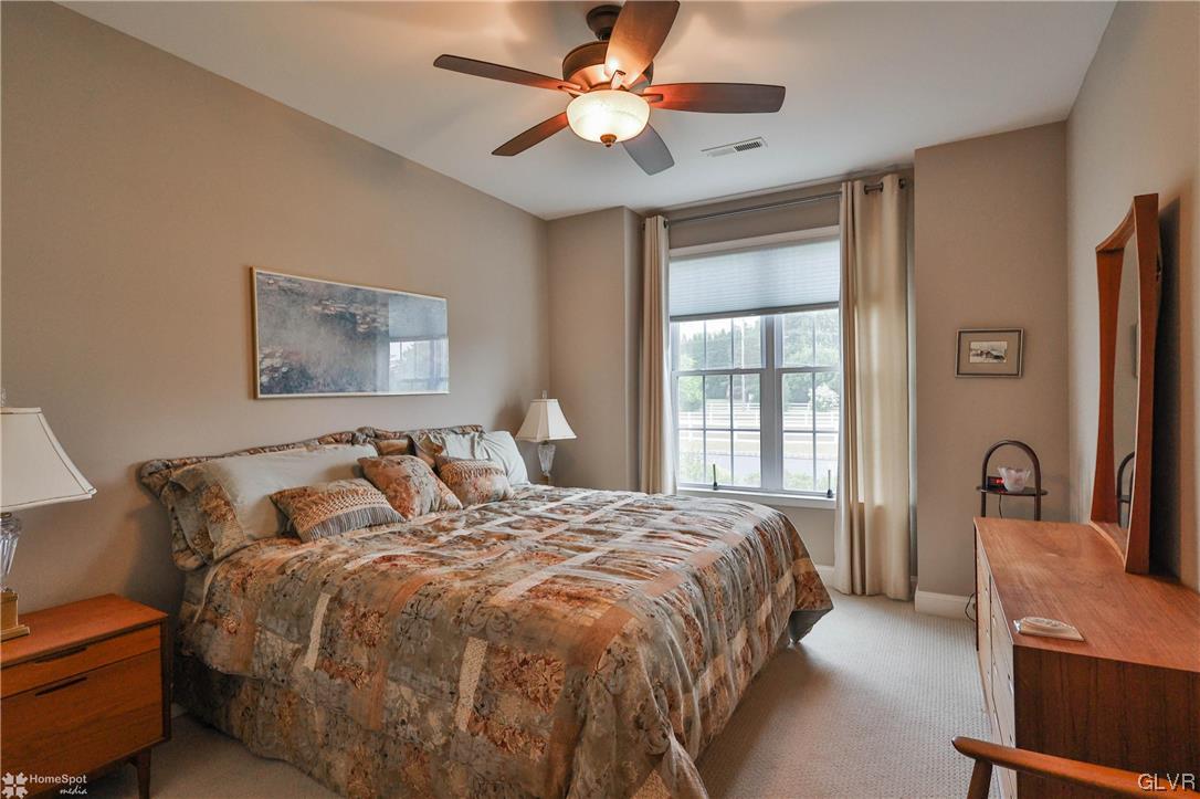 1035 Declaration Drive Bethlehem, PA 18017 - Photo 6 of 38 a bedroom with a large bed and a chandelier