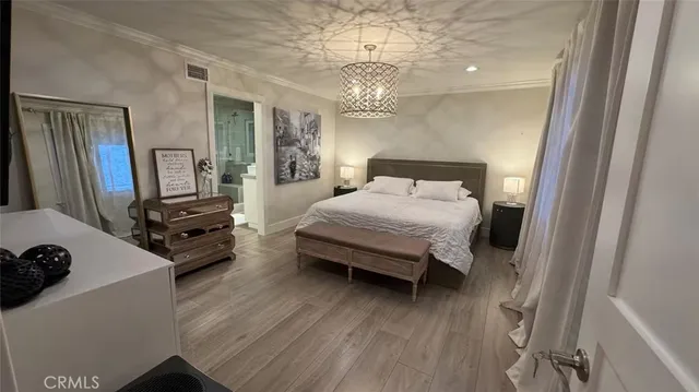 a bedroom with a bed window and a flat screen tv