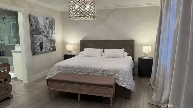a bedroom with a bed and a lamp on the dresser