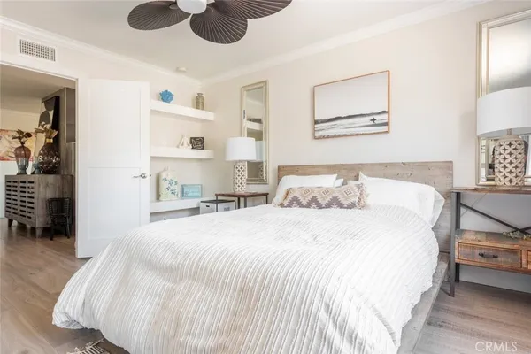 a spacious bedroom with a bed and a cabinets