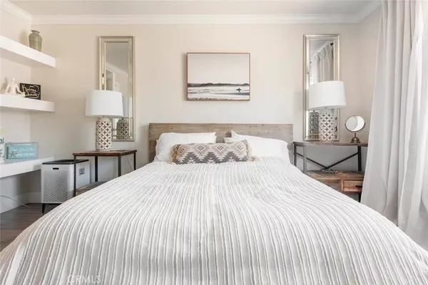 a bedroom with a bed and a mirror