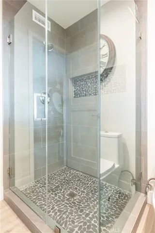 a bathroom with a toilet and a shower