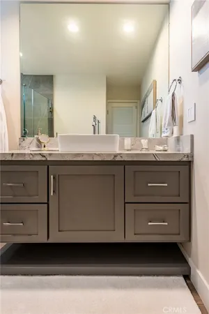 a bathroom with a granite countertop toilet sink and a mirror