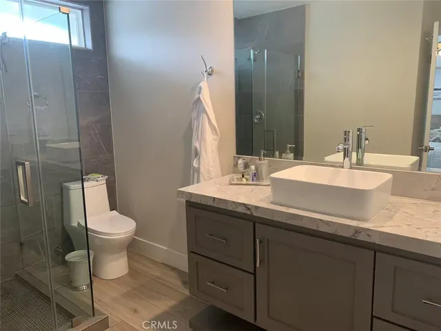 a bathroom with a toilet and a shower