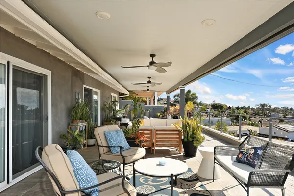 a view of a patio with dining table and chairs with wooden floor