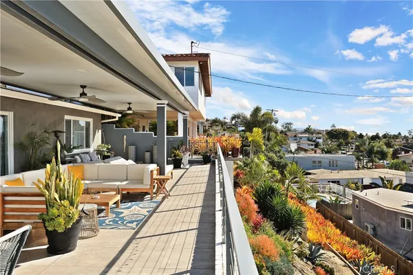 a view of a city from a balcony with furniture