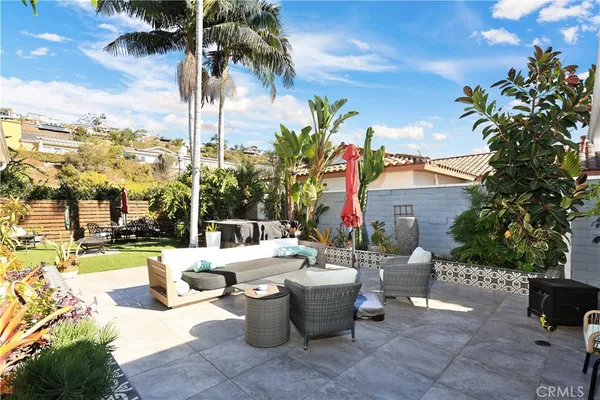 a view of a patio with couches and a fire pit