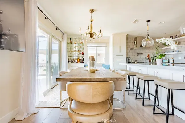 a dining table with chairs and chandelier