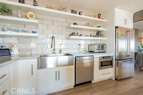 a kitchen with stainless steel appliances granite countertop a refrigerator and a sink