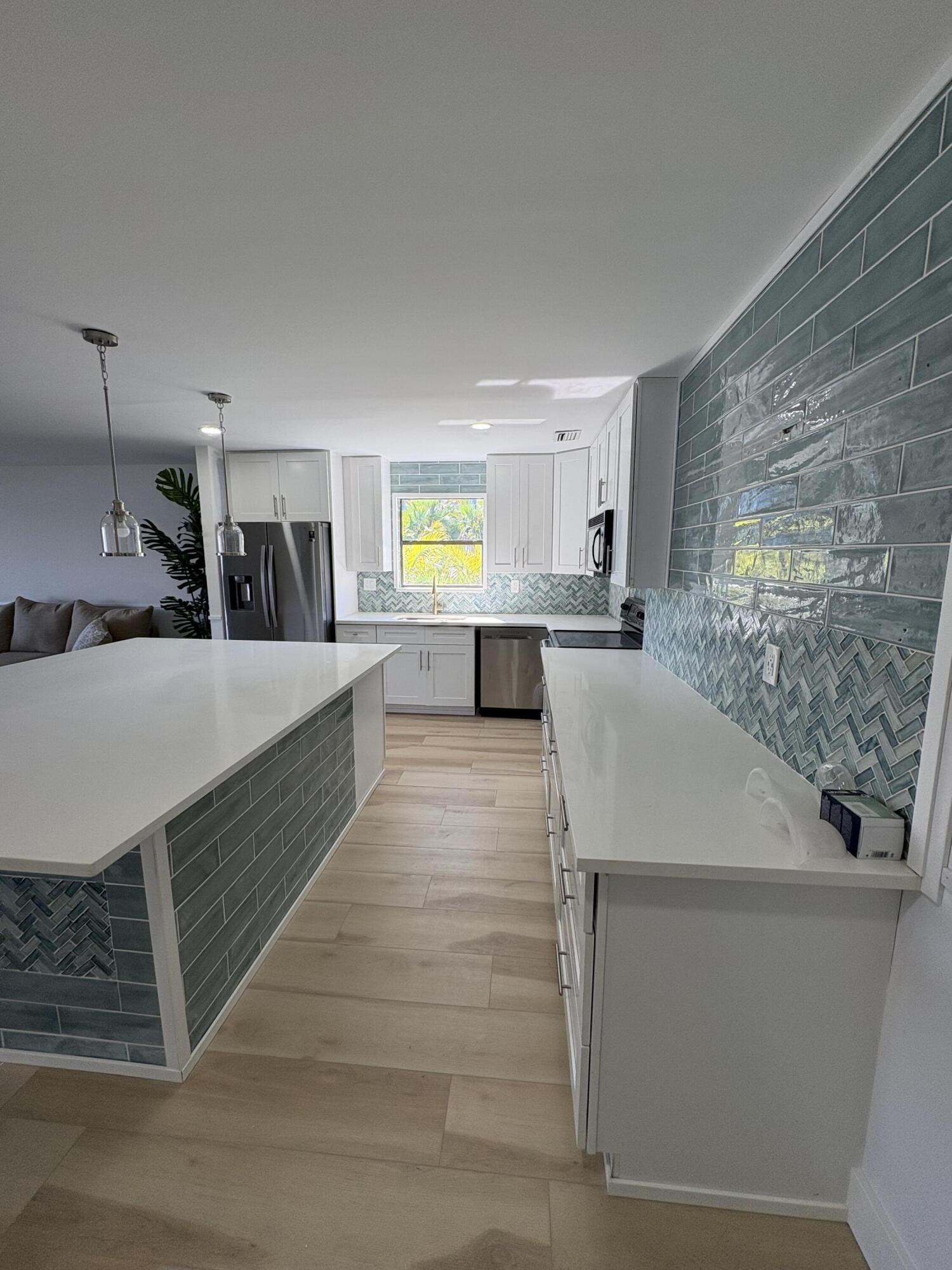 360 Wilma Circle, Unit 7 Riviera Beach, FL 33404 - Photo 13 of 15 a kitchen with sink and window