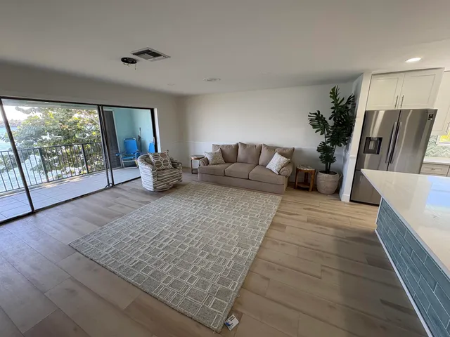a living room with furniture rug and a large window