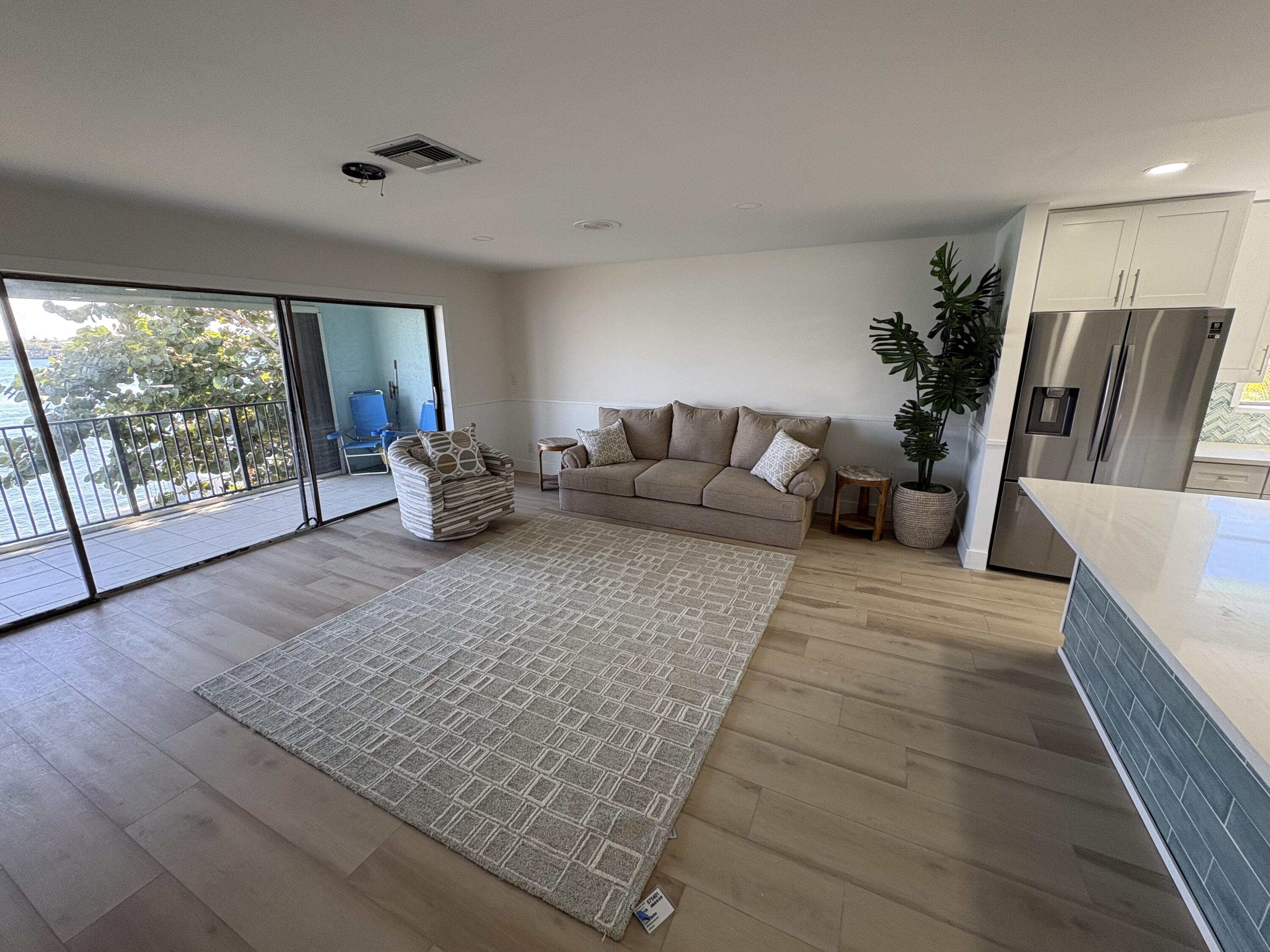 360 Wilma Circle, Unit 7 Riviera Beach, FL 33404 - Photo 7 of 15 a living room with furniture rug and a large window