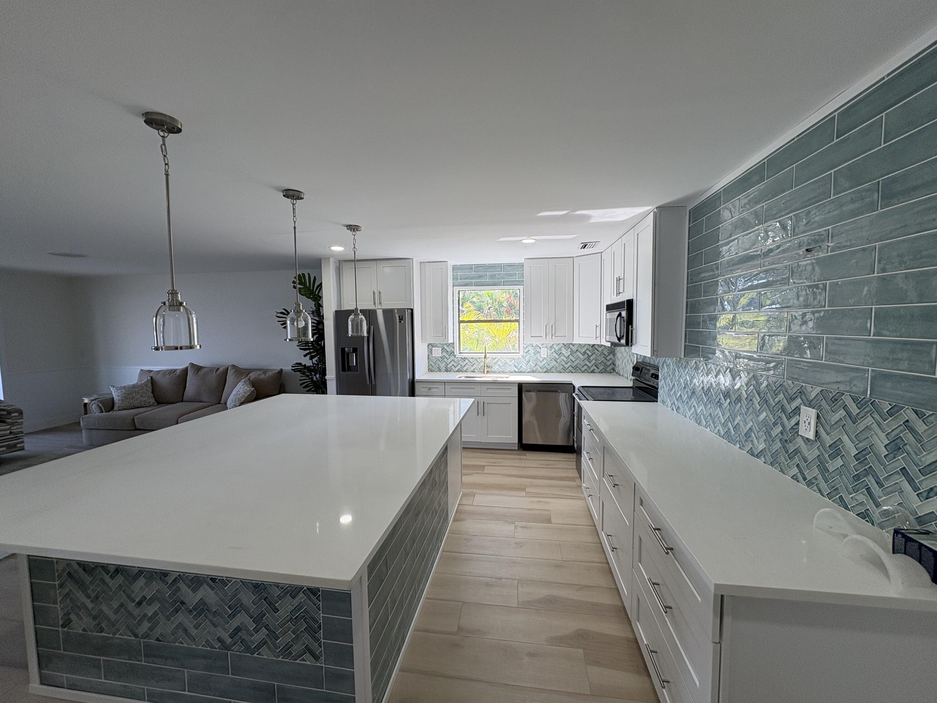 360 Wilma Circle, Unit 7 Riviera Beach, FL 33404 - Photo 8 of 15 a large white kitchen with sink and refrigerator