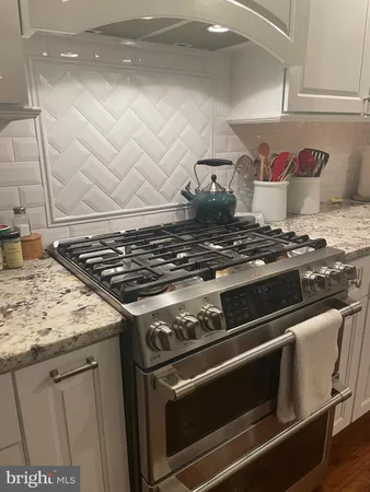 a stove top oven sitting inside of a kitchen