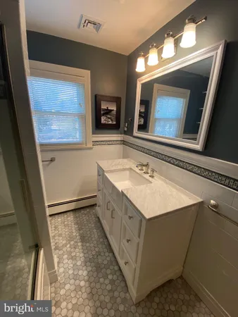 a bathroom with a sink a mirror and a