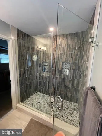 a bathroom with a shower and a sink