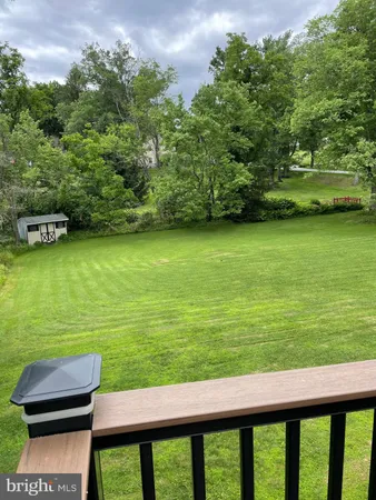 a view of a patio with chair and table of the ocean