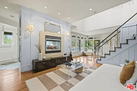 a living room with furniture window and wooden floor