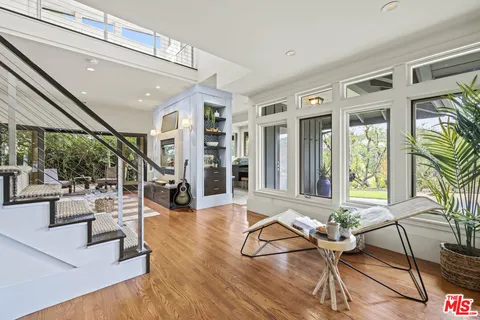 a view of a livingroom with furniture and floor to ceiling window