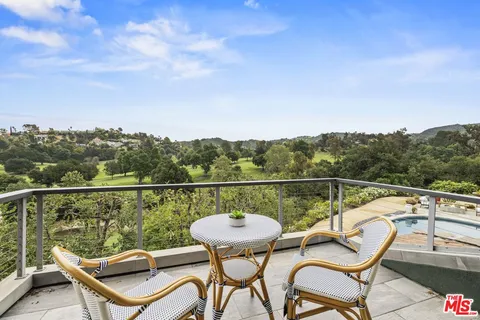 a view of a chairs and table on the balcony
