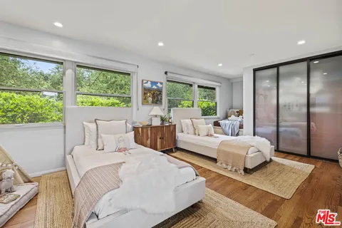 a spacious bedroom with a bed and a large window