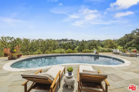 a view of a swimming pool with a lounge chair