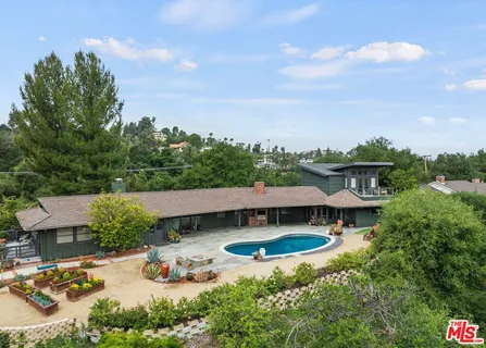 an aerial view of a house with yard basket ball court and outdoor seating