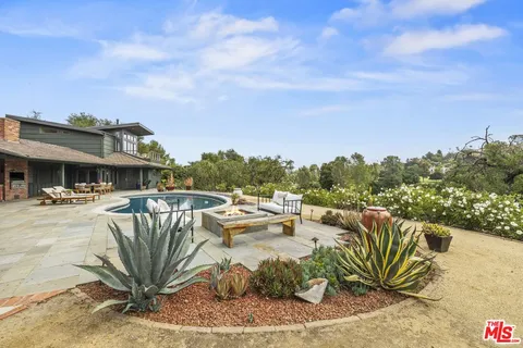 a view of a swimming pool and couches in the patio
