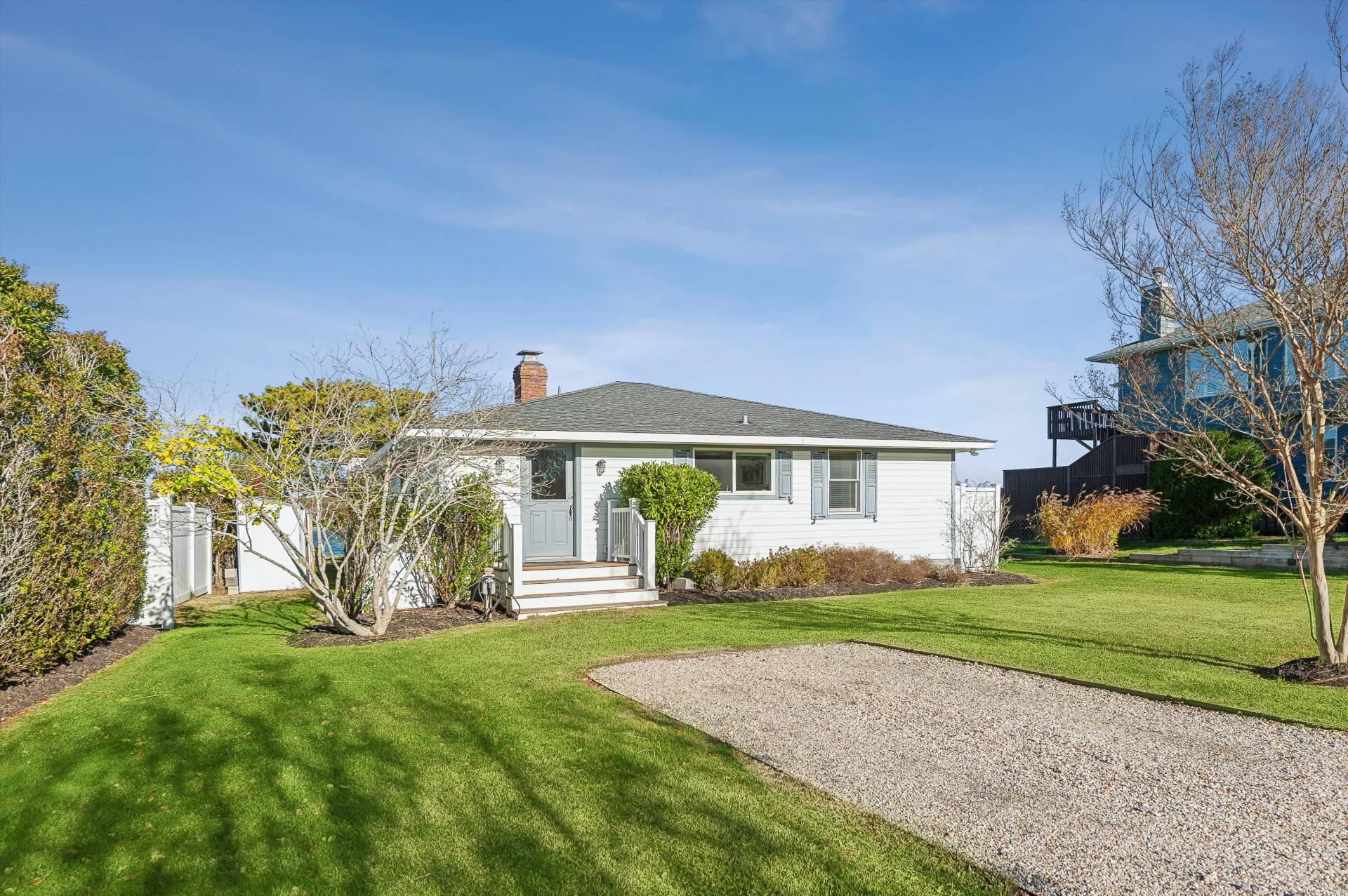 135 Little Neck Road Southampton, NY 11968 - Photo 3 of 20 a front view of a house with garden