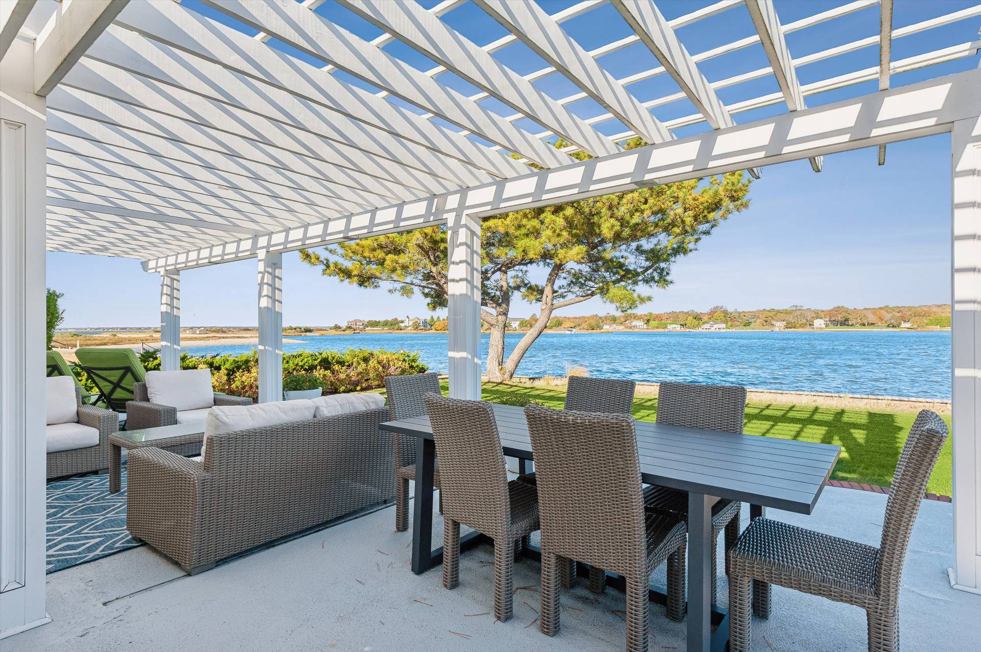 135 Little Neck Road Southampton, NY 11968 - Photo 6 of 20 a view of a patio with a table and chairs