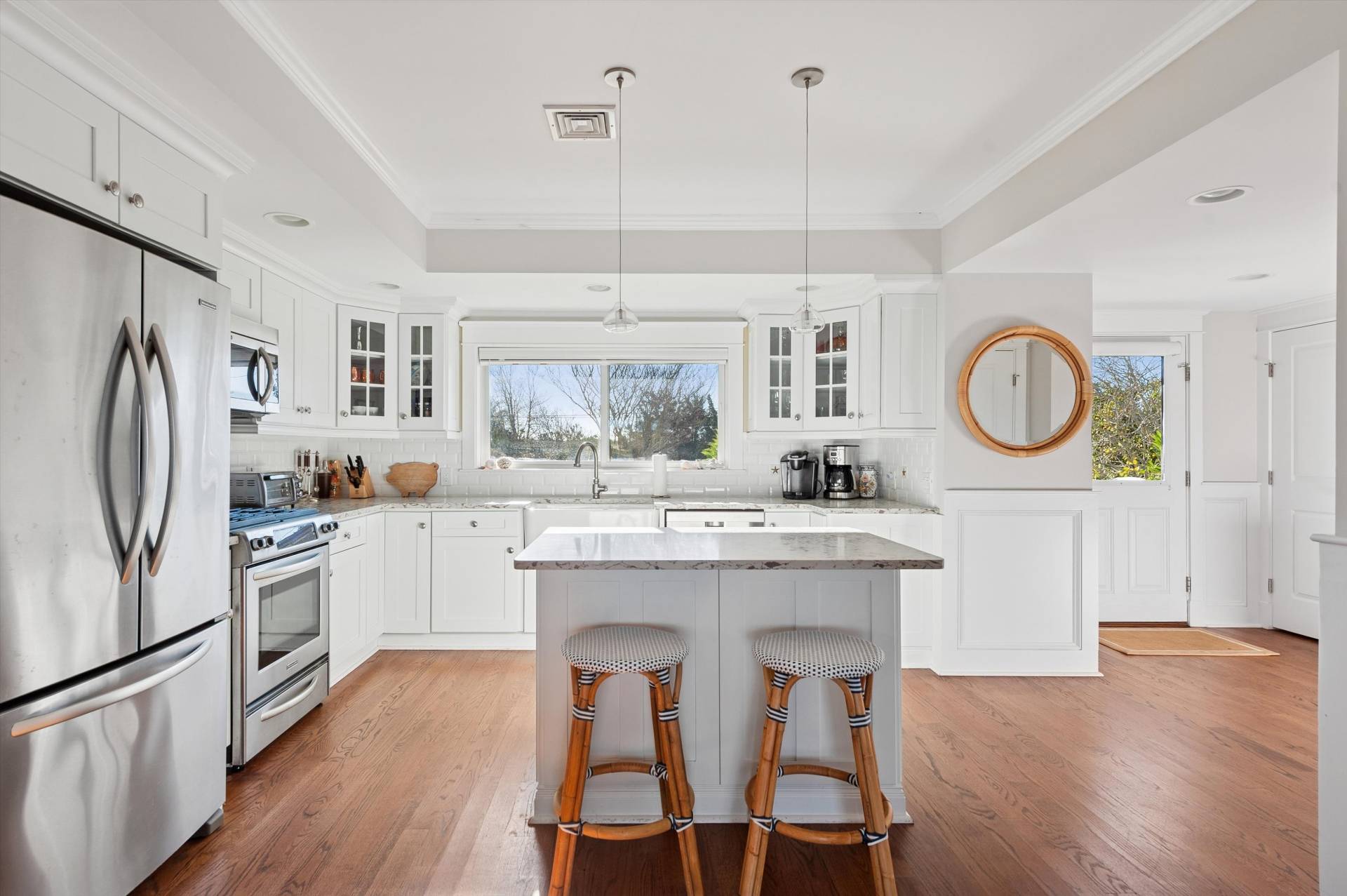 135 Little Neck Road Southampton, NY 11968 - Photo 10 of 20 a kitchen with stainless steel appliances granite countertop a refrigerator a stove a sink dishwasher a dining table and chairs with wooden floor