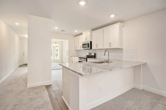 a kitchen with stainless steel appliances granite countertop a sink and cabinets