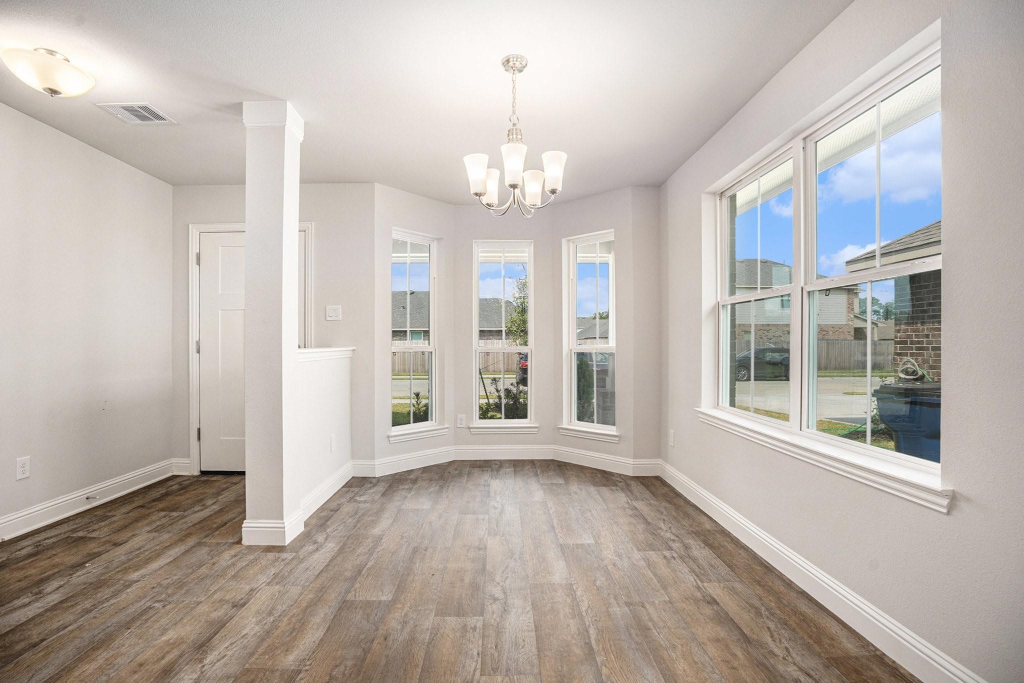 412 Bryan Way Angleton, TX 77515 - Photo 4 of 15 a view of an empty room with wooden floor and a window