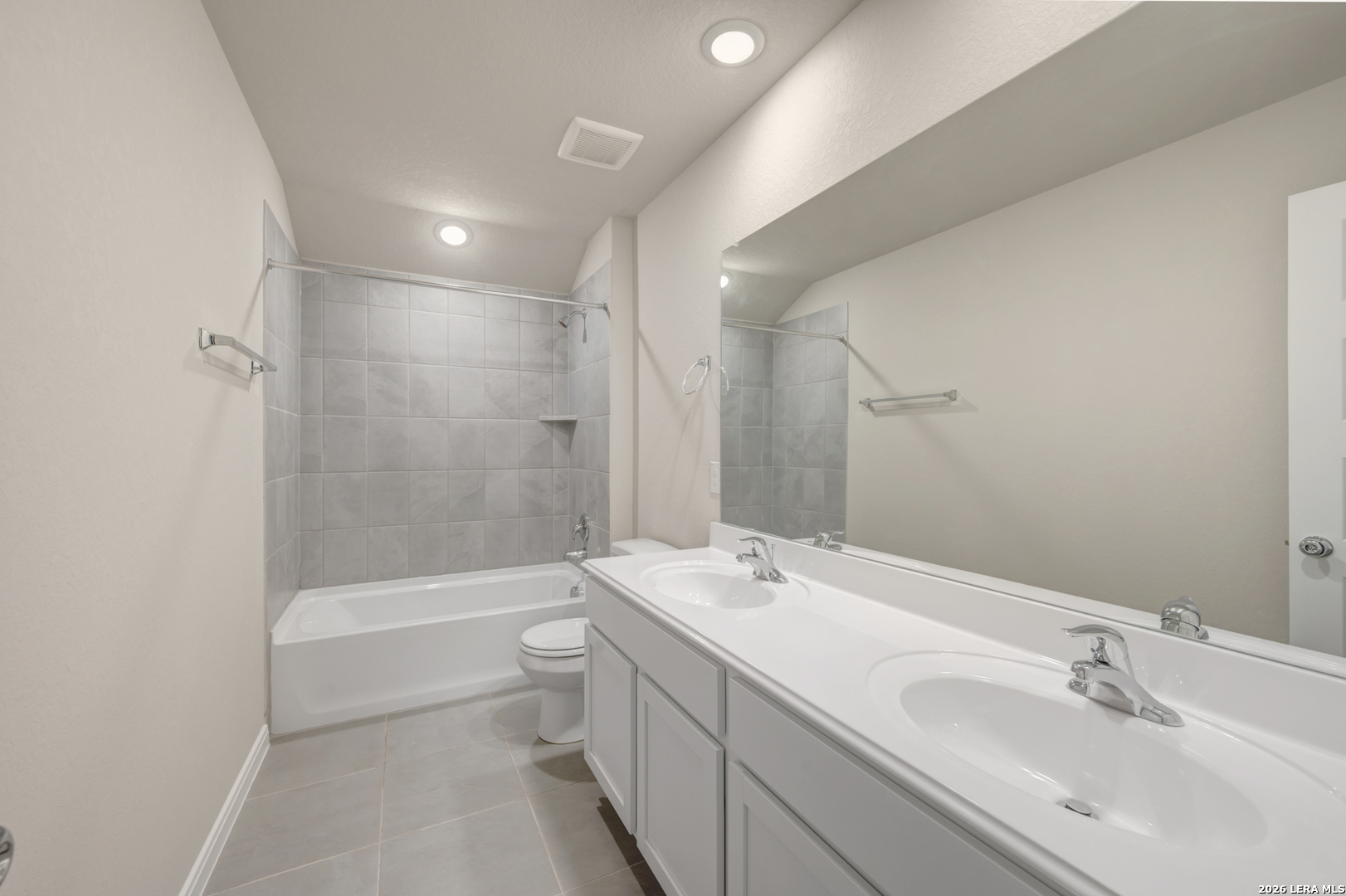 10330 Goodison Drive Converse, TX 78109 - Photo 36 of 42 a bathroom with a double vanity sink toilet and shower
