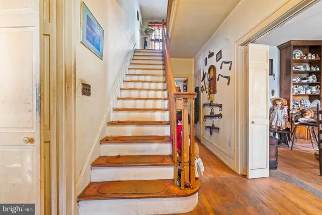 a view of entryway with furniture and wooden floor
