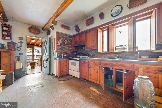 a large kitchen with stainless steel appliances granite countertop a stove and a sink