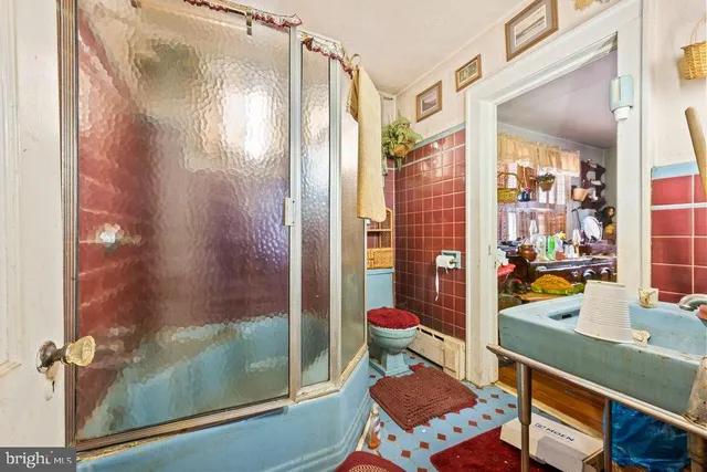 a bathroom with a sink mirror and a shower