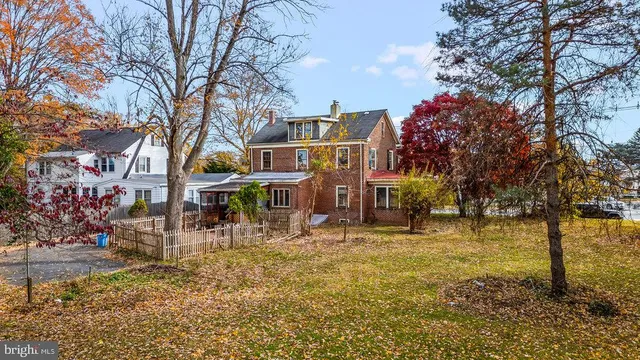 a view of a house with large trees