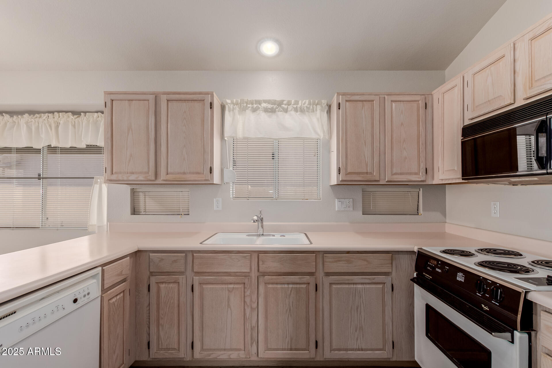 14588 West Bison Path Surprise, AZ 85374 - Photo 15 of 42 a kitchen with granite countertop white cabinets and stainless steel appliances