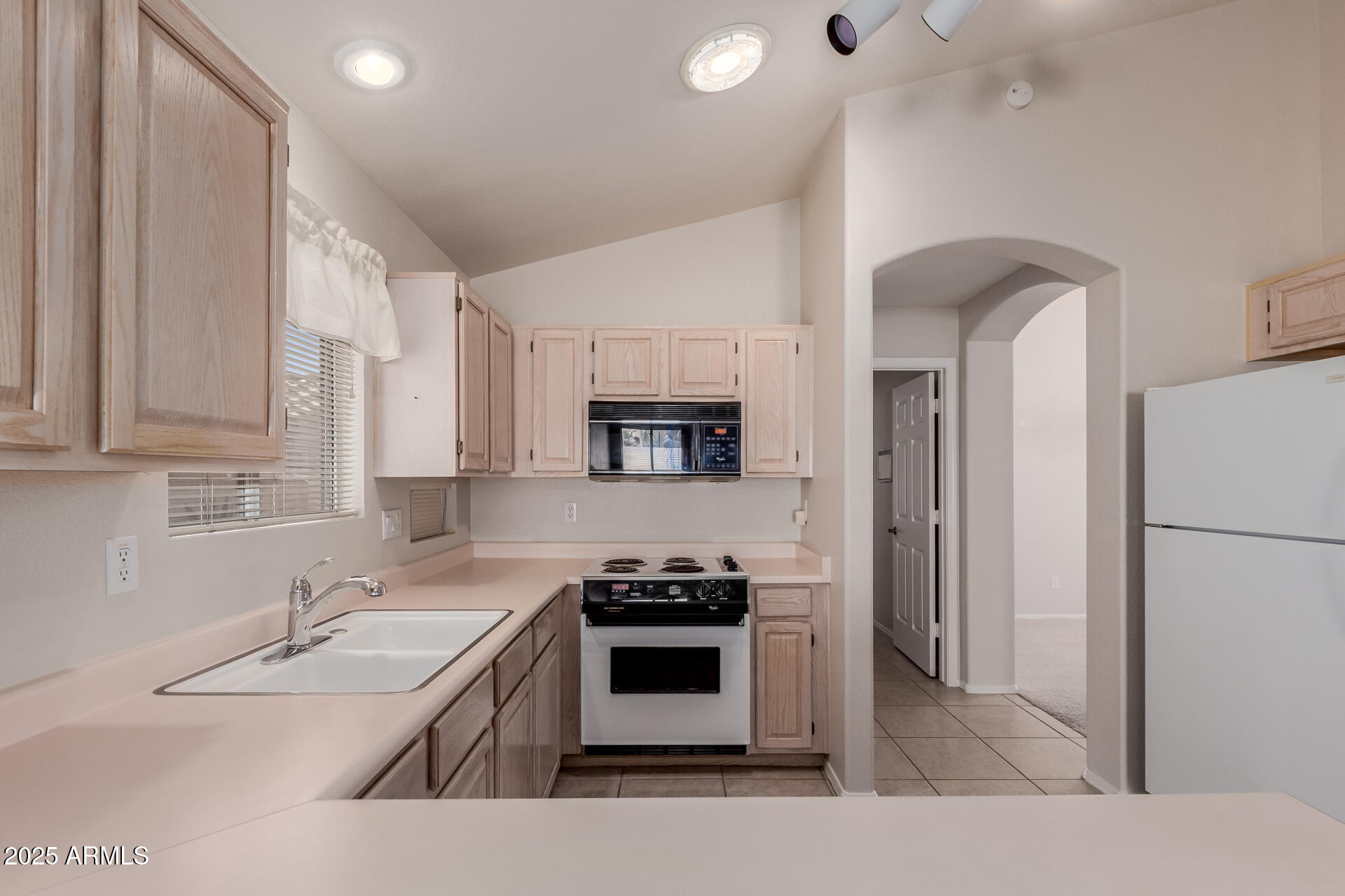 14588 West Bison Path Surprise, AZ 85374 - Photo 16 of 42 a kitchen with stainless steel appliances a stove a sink and a refrigerator