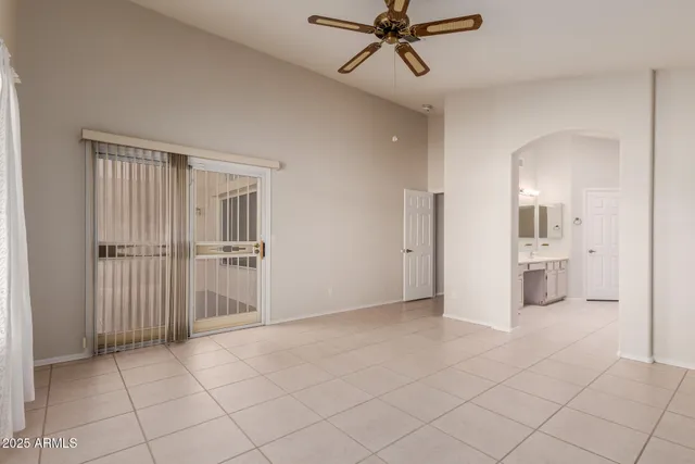 a view of a room with a stylish ceiling fan and entryway