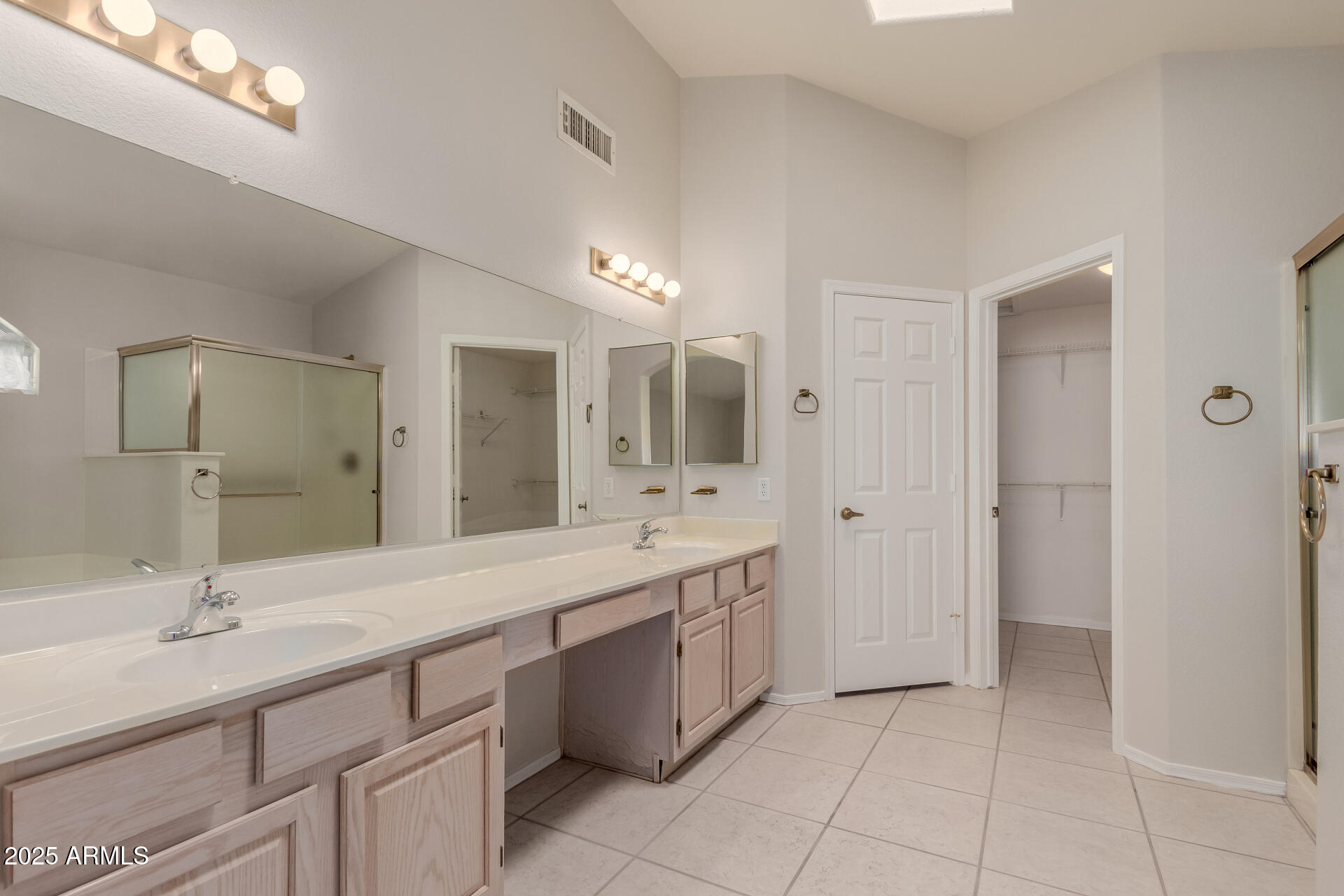 14588 West Bison Path Surprise, AZ 85374 - Photo 23 of 42 a bathroom with a double vanity sink a mirror and a bathtub