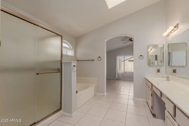 a bathroom with a sink a mirror and a shower